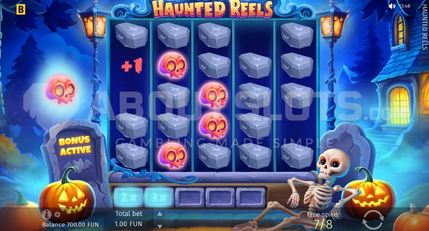 Skeleton beneath the reels during bonus game in Haunted Reels