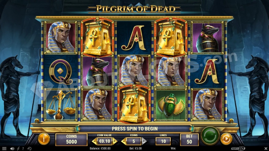 Base game with two large jackal statues standing opposite the reels